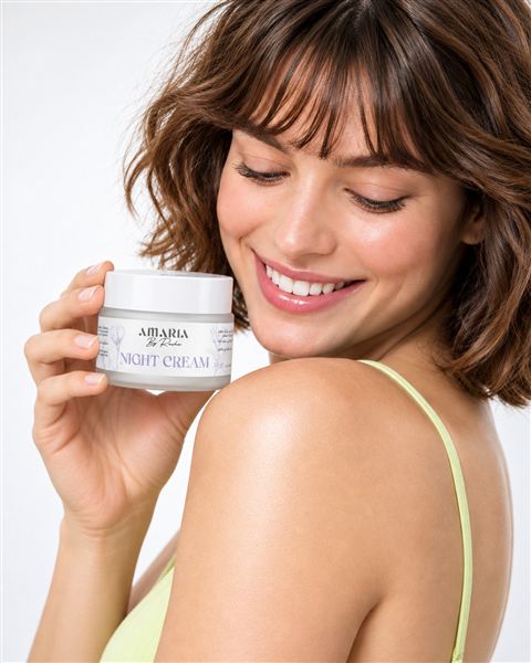 A smiling woman holding the Amaria Night Cream