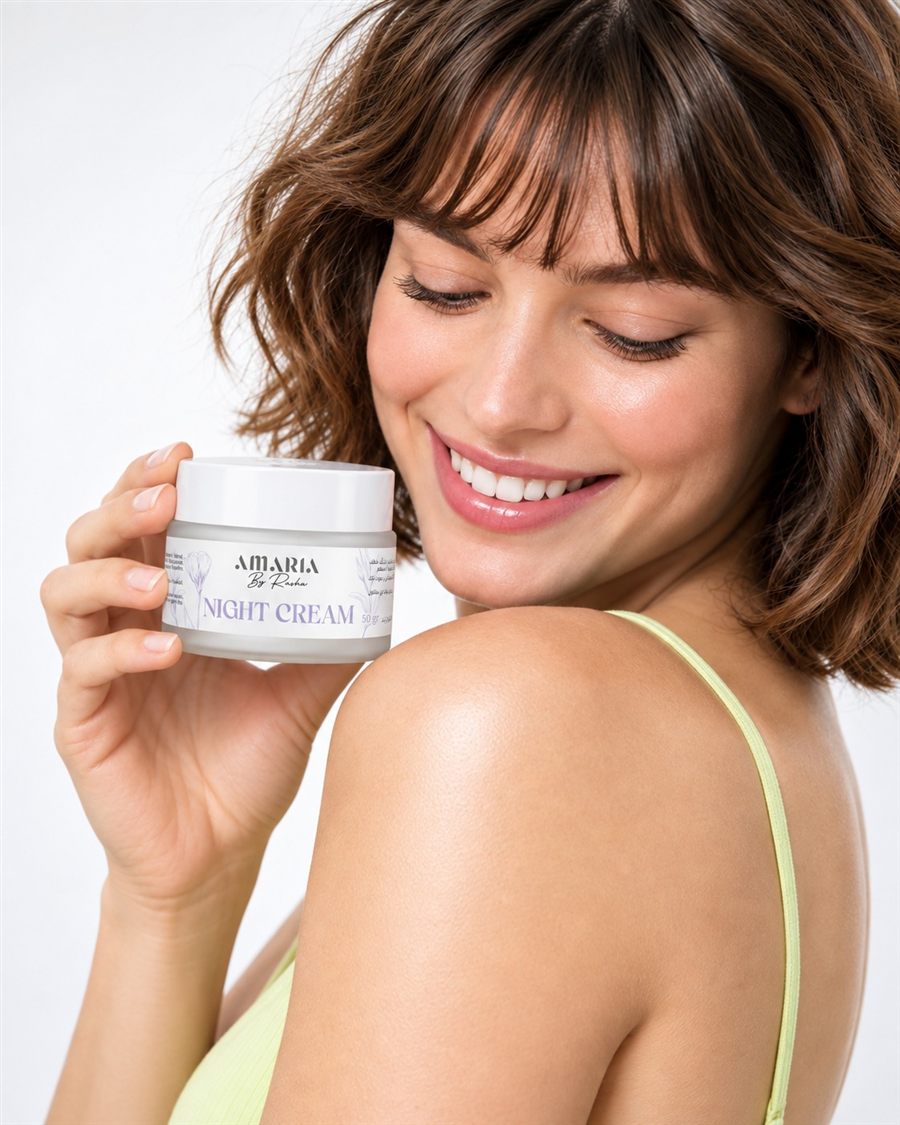 A smiling woman holding the Amaria Night Cream